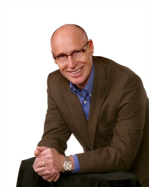 Frank Rudge, RE/MAX REALTOR® in Victoria BC, smiling in a brown blazer